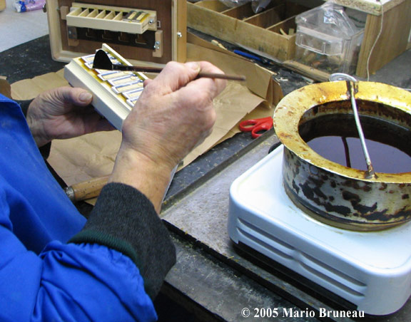 Reedwaxing Accordion reeds are waxed on reedblock
